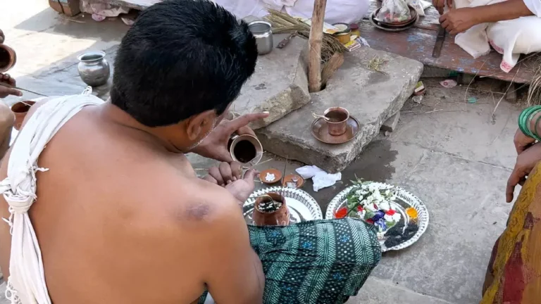 A devotee worshipping the Asthi during asthi visarajan pooja-Asthi Visarjan at Varanasi