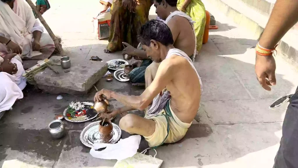 What safety precautions should be taken while performing the ritual at the ghats or in the river?