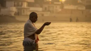 Image of a man taking dip in holy sangam- NRI shradh puja Prayagraj