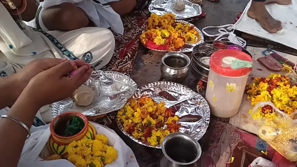 Image of a person doing ritual for their loved once- Pind Daan in Prayagraj from Singapore
